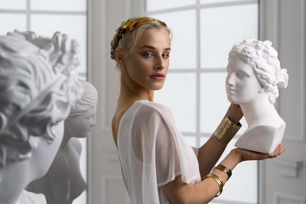 Medium shot woman posing as greek goddess; Design by Freepik